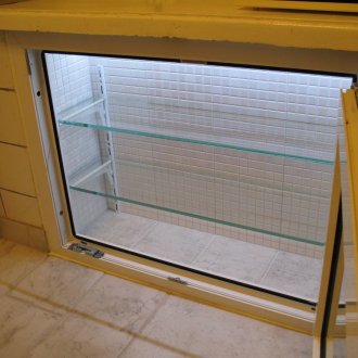 Refrigerator under the window with light
