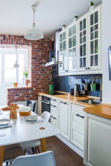 Fridge under the window in the kitchen