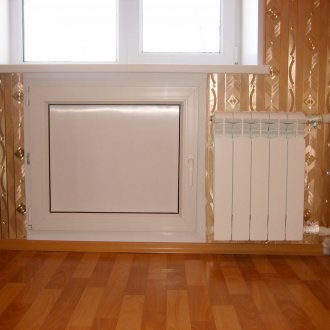 The refrigerator under the window is winter