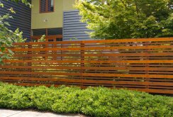 Modern wooden fence on the plot