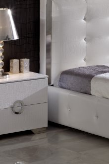 White bedside table covered with faux leather