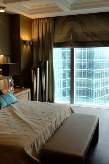 Комбинацията от конвенционални и римски завеси в спалнята