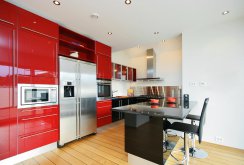 Red kitchen set with black and metal furniture in the kitchen